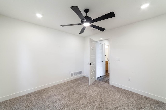 unfurnished bedroom featuring ceiling fan and dark colored carpet