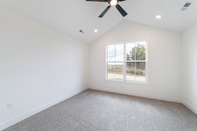 carpeted empty room featuring ceiling fan and vaulted ceiling