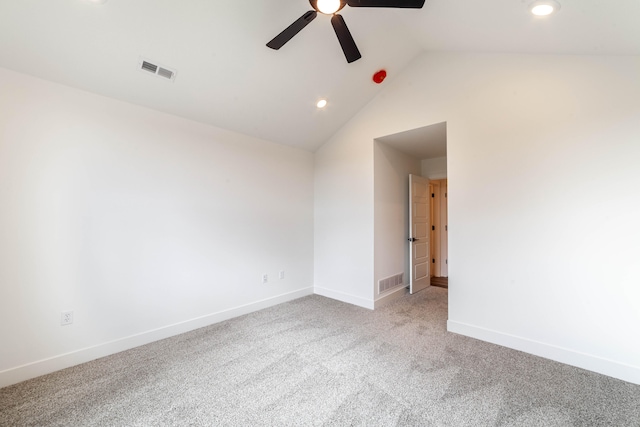 carpeted empty room with ceiling fan and lofted ceiling