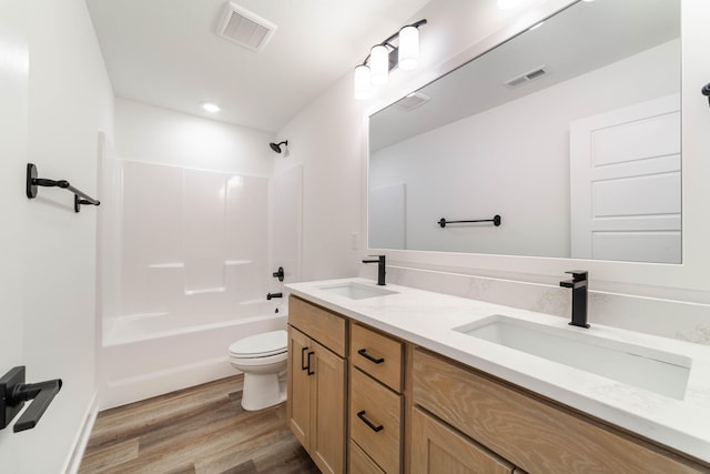 full bathroom with wood-type flooring, vanity, toilet, and shower / bathtub combination