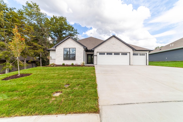 view of front of home with a garage and a front lawn