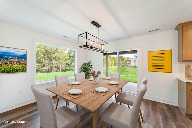 dining room featuring an inviting chandelier and dark hardwood / wood-style flooring