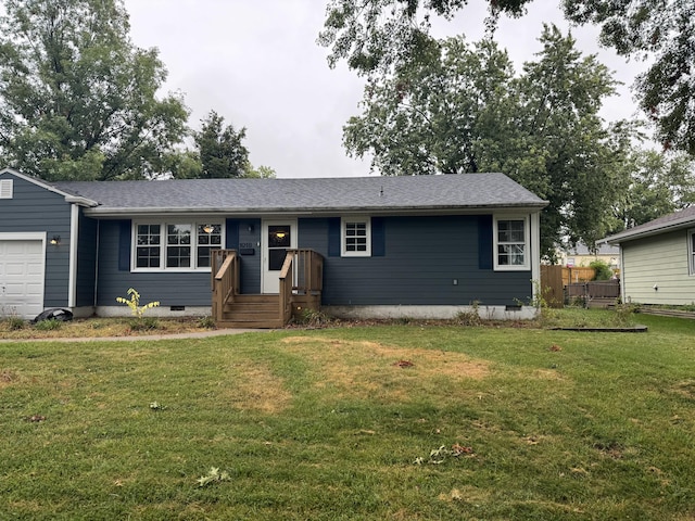 ranch-style house featuring a front yard and a garage