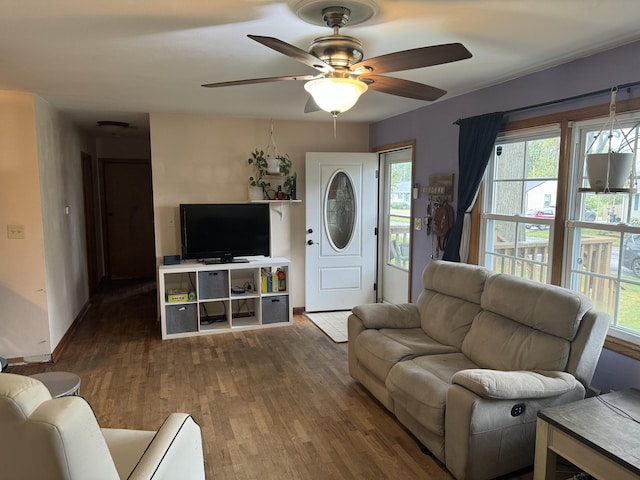 living room featuring ceiling fan, plenty of natural light, and wood-type flooring