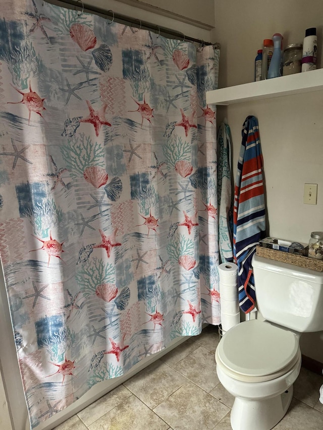 bathroom with toilet and tile patterned flooring