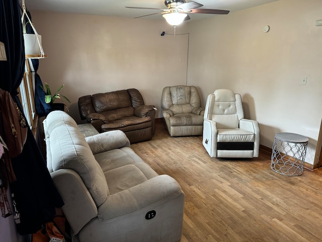 living room with ceiling fan and light wood-type flooring