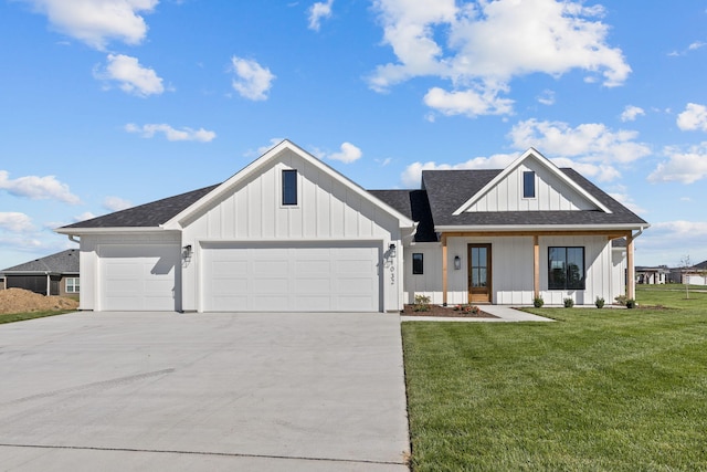 modern inspired farmhouse with a front lawn and a garage