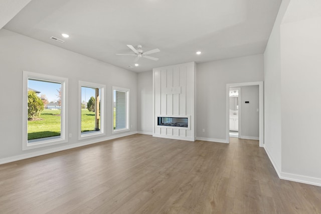 unfurnished living room featuring light hardwood / wood-style floors and ceiling fan