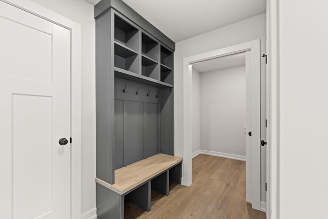 mudroom with light wood finished floors and baseboards