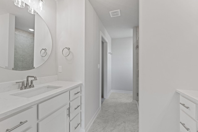 full bathroom with marble finish floor, vanity, baseboards, and visible vents