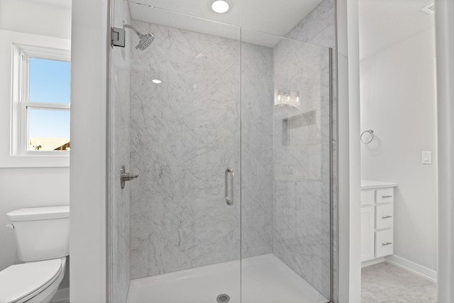 bathroom featuring toilet, vanity, a marble finish shower, marble finish floor, and baseboards