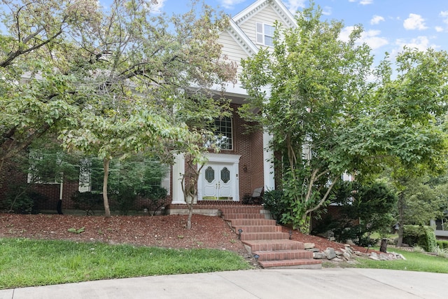 obstructed view of property with brick siding