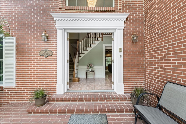 doorway to property featuring brick siding