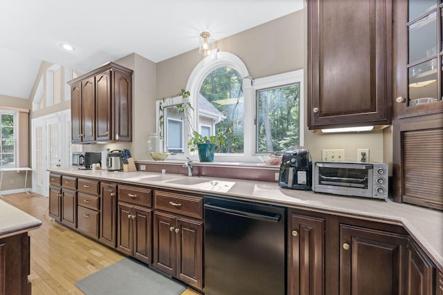 kitchen with black dishwasher, lofted ceiling, light countertops, glass insert cabinets, and dark brown cabinetry