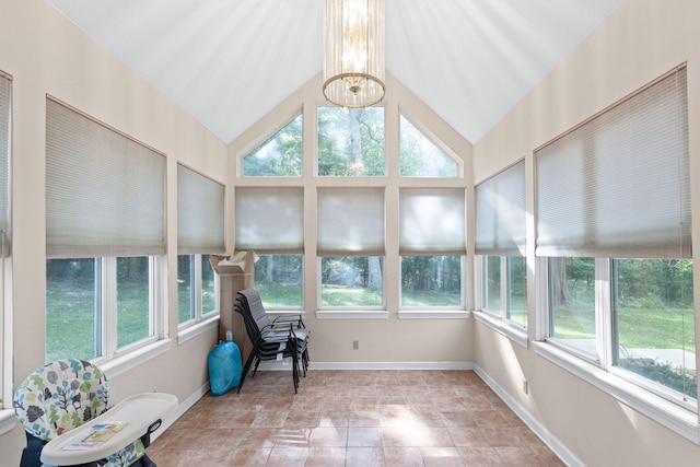 sunroom featuring lofted ceiling and a notable chandelier