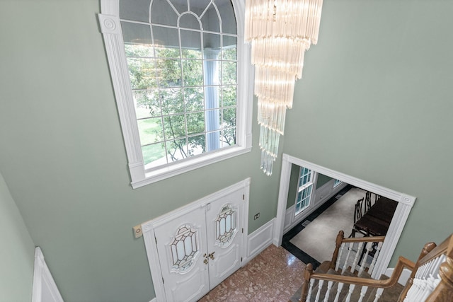 foyer entrance with a notable chandelier