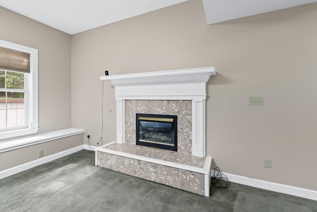 room details featuring carpet floors, baseboards, and a tiled fireplace