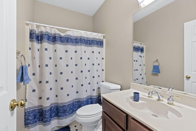 bathroom with curtained shower, vanity, and toilet