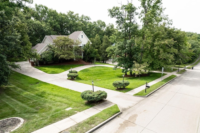 view of property's community with a yard