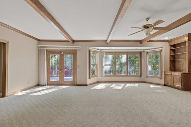 unfurnished living room featuring light colored carpet, beam ceiling, a healthy amount of sunlight, and baseboards