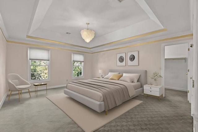 carpeted bedroom with a tray ceiling, crown molding, visible vents, a spacious closet, and baseboards