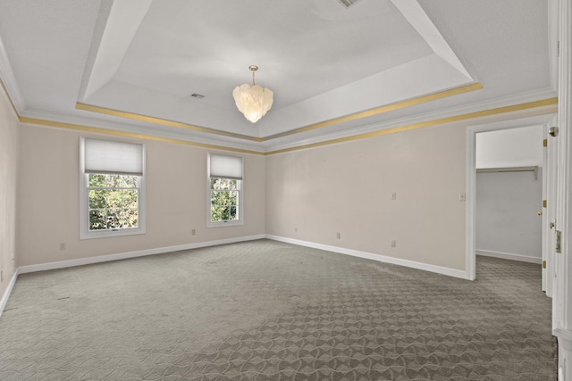 unfurnished room featuring carpet floors, baseboards, and a tray ceiling