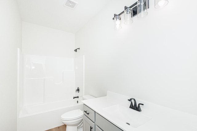 full bathroom featuring toilet, wood finished floors, vanity, visible vents, and washtub / shower combination