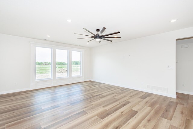 empty room featuring ceiling fan and light hardwood / wood-style floors