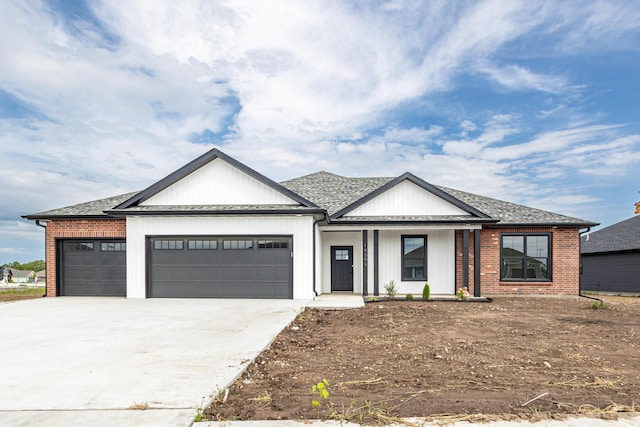 view of front of house with brick siding, roof with shingles, covered porch, concrete driveway, and an attached garage