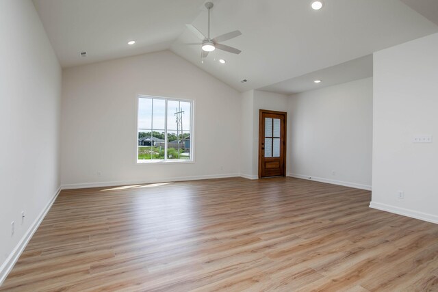 spare room with light hardwood / wood-style flooring, ceiling fan, and high vaulted ceiling