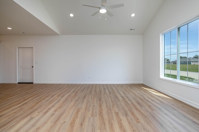 unfurnished room featuring ceiling fan, light wood-type flooring, and lofted ceiling