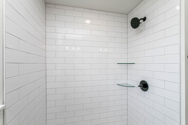 bathroom with tiled shower