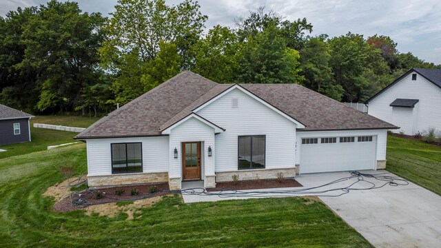 view of front of property with a garage and a front lawn