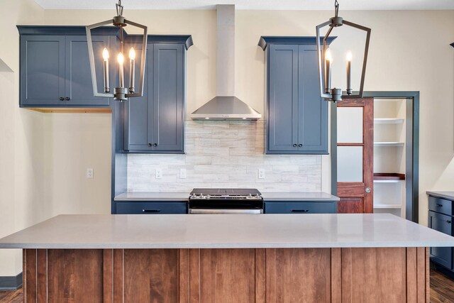 kitchen with stainless steel range, backsplash, dark hardwood / wood-style flooring, and wall chimney exhaust hood