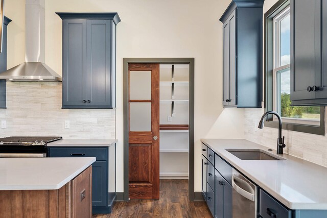 kitchen featuring dark hardwood / wood-style floors, wall chimney exhaust hood, backsplash, stainless steel appliances, and sink