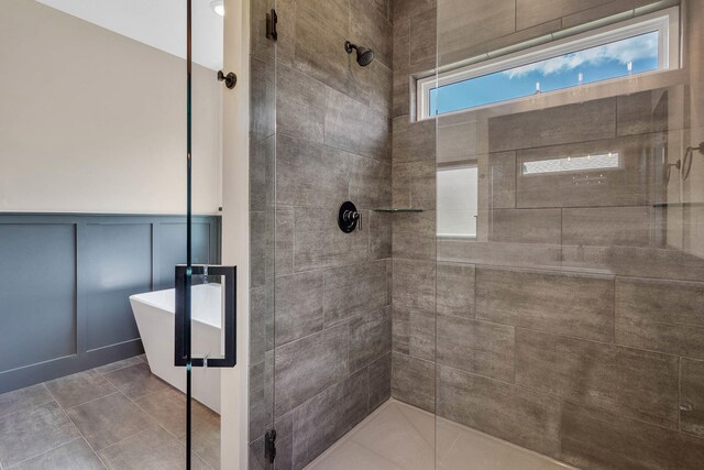 bathroom featuring plus walk in shower and tile patterned floors