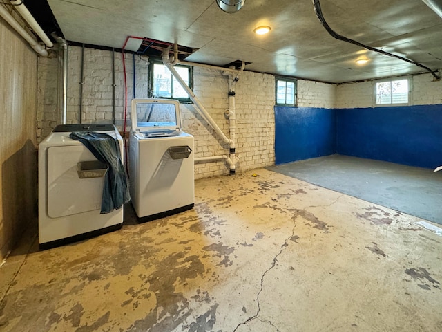 basement featuring a healthy amount of sunlight and washing machine and dryer