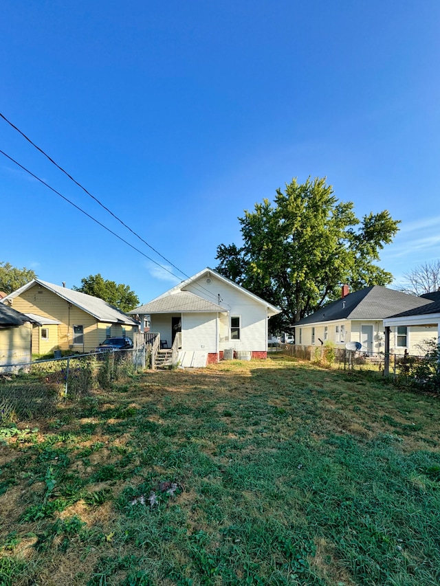 rear view of house with a yard