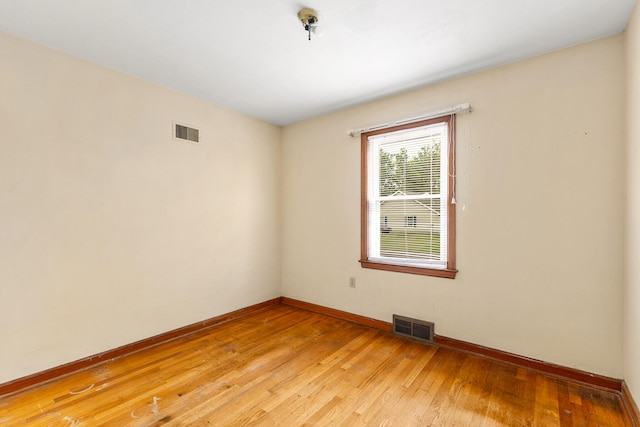 spare room with wood-type flooring