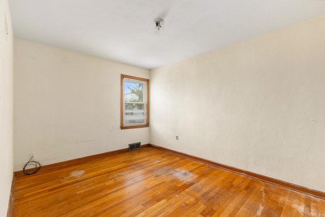 spare room with wood-type flooring