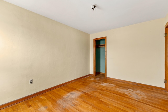 empty room with light hardwood / wood-style flooring