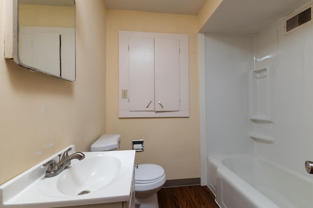 full bathroom with shower / tub combination, hardwood / wood-style floors, toilet, and vanity