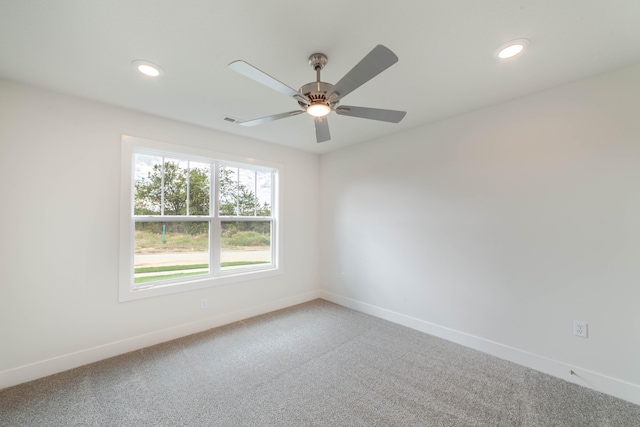 empty room with ceiling fan and carpet flooring