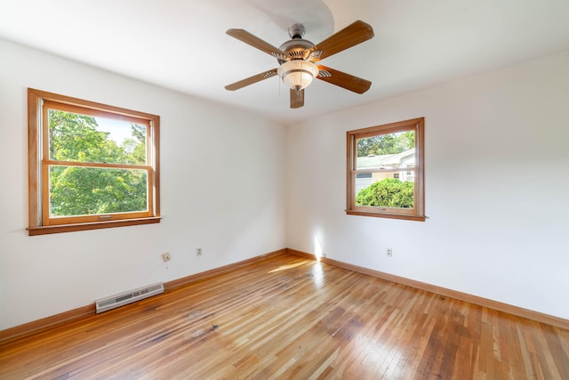 spare room featuring light hardwood / wood-style flooring and ceiling fan