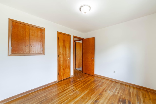 unfurnished room featuring hardwood / wood-style flooring