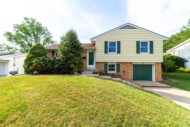 tri-level home with an attached garage, brick siding, driveway, and a front lawn