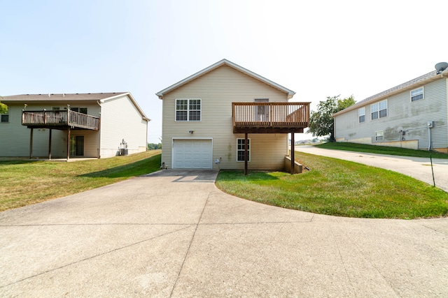 view of front of property featuring a garage, a deck, and a front yard