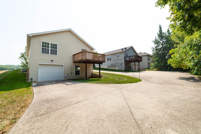 view of side of home with a garage, a balcony, and a lawn