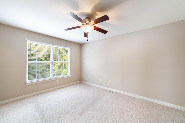 carpeted empty room featuring ceiling fan