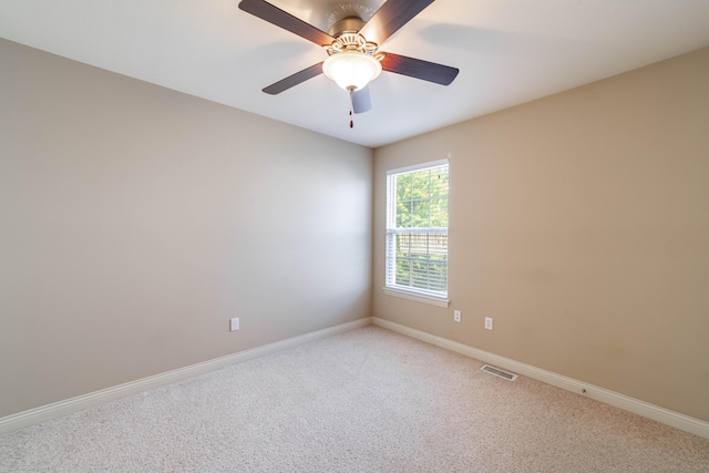 carpeted spare room with ceiling fan